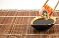Sushi roll with salmon cucumber and cheese with chopsticks Royalty Free Stock Photo