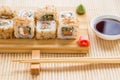 Sushi roll with salmon, cucumber and tuna skin on a wooden board Royalty Free Stock Photo