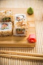 Sushi roll with salmon, cucumber and tuna skin on a wooden board Royalty Free Stock Photo