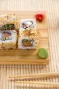 Sushi roll with salmon, cucumber and tuna skin on a wooden board Royalty Free Stock Photo