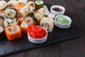 Sushi Roll with salmon, eel, tuna, avocado, cream cheese Philadelphia, caviar tobica, chuka. Sushi menu. Japanese food on table Royalty Free Stock Photo