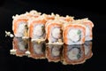 Sushi Roll with Salmon and shrimp over black background with re