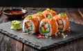 Sushi roll with salmon, smoked eel, avocado, cream cheese on a black background. Sushi menu. Japanese food. Royalty Free Stock Photo