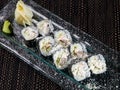 Sushi roll with seafood and avocado on a glass plate on dark background Royalty Free Stock Photo