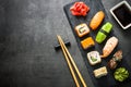 Sushi and sushi roll set on black stone table top view Royalty Free Stock Photo