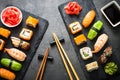 Sushi and sushi roll set on black stone table top view Royalty Free Stock Photo