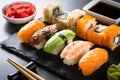 Sushi and sushi roll set on black stone table. Royalty Free Stock Photo