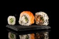Sushi roll set with salmon, smoked eel, cucumber, cream cheese on a graphite stand