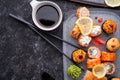 Sushi roll set served at grey desk at black table. flat lay Royalty Free Stock Photo