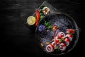 Sushi roll with tuna, cream cheese, cucumber, rice in plate on black wooden table Royalty Free Stock Photo