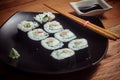 Sushi roll with tuna and cucumber on black plate Royalty Free Stock Photo