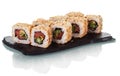 Sushi rolls arranged on special black plate isolated on white Royalty Free Stock Photo