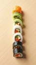 Sushi Rolls Arranged in a Vertical Gradient Transitioning from Light Cucumber Rolls to Dark Eel Rolls Royalty Free Stock Photo