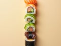 Sushi Rolls Arranged in a Vertical Gradient Transitioning from Light Cucumber Rolls to Dark Eel Rolls Royalty Free Stock Photo