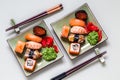 Sushi rolls on round slate black Board with wasabi and ginger Royalty Free Stock Photo