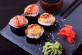 Sushi rolls assortment, wasabi, marinated ginger and soy sauce served on slate plate Royalty Free Stock Photo