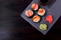 Sushi rolls assortment, wasabi, marinated ginger and soy sauce served on slate plate Royalty Free Stock Photo