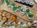 Sushi rolls with avocado and fried onion and agri-sweet sauce on wooden board