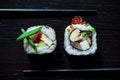 Sushi rolls with caviar, green onion, philadelphia, cucumber, omelette top view on black tableboard. Japanese food concept. Still Royalty Free Stock Photo