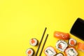 Sushi rolls, chopsticks and soy on background, top view Royalty Free Stock Photo