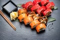 Sushi rolls closeup. Japanese food in restaurant. California sushi roll set with salmon, eel, vegetables and flying fish caviar Royalty Free Stock Photo