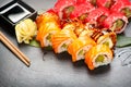 Sushi rolls closeup. Japanese food in restaurant. California sushi roll set with salmon, eel, vegetables and flying fish caviar Royalty Free Stock Photo