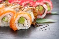 Sushi rolls closeup. Japanese food in restaurant. California sushi roll set with salmon, eel, vegetables and flying fish caviar Royalty Free Stock Photo