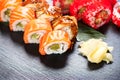 Sushi rolls closeup. Japanese food in restaurant. Roll with salmon, eel, vegetables and flying fish caviar Royalty Free Stock Photo