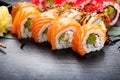 Sushi rolls closeup. Japanese food in restaurant. Roll with salmon, eel, vegetables and flying fish caviar Royalty Free Stock Photo