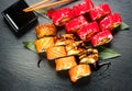 Sushi rolls closeup. Japanese food in restaurant. Roll with salmon, eel, vegetables and flying fish caviar Royalty Free Stock Photo