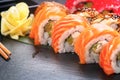 Sushi rolls closeup. Japanese food in restaurant. Roll with salmon, eel, vegetables and flying fish caviar Royalty Free Stock Photo