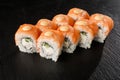 Sushi Rolls with cucumber, shrimp, salmon and Cream Cheese inside on black slate isolated. Philadelphia roll sushi with shrimp. Royalty Free Stock Photo