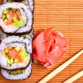 Sushi, rolls, ginger and chopstick on bamboo mat