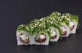 Sushi Rolls Green Roll with RICE, CREAM CHEESE, CUCUMBER, SALMON, WAKAME AND SEZAM