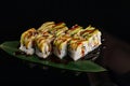 Sushi rolls japanese food over black background. Sushi roll with salmon, tofu, vegetables and avocado closeup. Japan restaurant Royalty Free Stock Photo