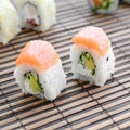 Sushi rolls lies on a bamboo straw serwing mat. Traditional Asian food. Shallow depth of field