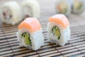 Sushi rolls lies on a bamboo straw serwing mat. Traditional Asian food. Shallow depth of field