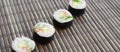 Sushi rolls lies on a bamboo straw serwing mat. Traditional Asian food