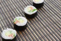 Sushi rolls lies on a bamboo straw serwing mat. Traditional Asian food