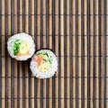 Sushi rolls lies on a bamboo straw serwing mat. Traditional Asian food. Top view. Flat lay minimalism shot with copy space