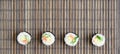 Sushi rolls lies on a bamboo straw serwing mat. Traditional Asian food. Top view. Flat lay minimalism shot with copy space