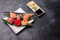 Sushi rolls made of rice, smoked eel, cream cheese and flying fish set hot rolls with avacado, salmon, cream cheese, seaweed, soy Royalty Free Stock Photo