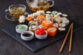 Sushi rolls, maki, nigiri Set served for two on black stone slate on dark background Royalty Free Stock Photo