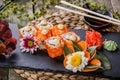 Sushi Rolls - Maki Sushi sashimi decorated with flowers. Japanese cuisine. Selective focus. Royalty Free Stock Photo