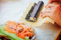 Sushi rolls making hands at home Royalty Free Stock Photo