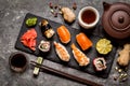 Sushi and sushi rolls, sushi nigiri on stone plate on dark background, mustard wasabi Royalty Free Stock Photo