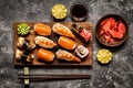 Sushi and sushi rolls, sushi nigiri on stone plate on dark background Royalty Free Stock Photo