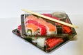 Sushi rolls pack in plastic container on white background