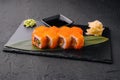 Sushi rolls philadelphia on a black slate