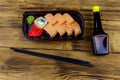 Sushi rolls Philadelphia in plastic box on wooden table. Top view